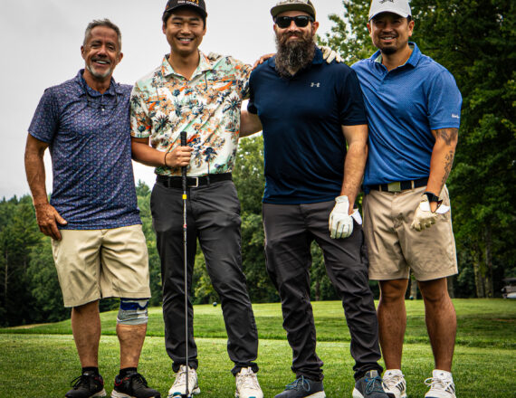 Four Men on a golf course taking a portrait
